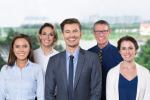 Successful Business Team Smiling at Camera Portrait of happy young business leader standing with his successful team. They smiling at camera. Business team concept